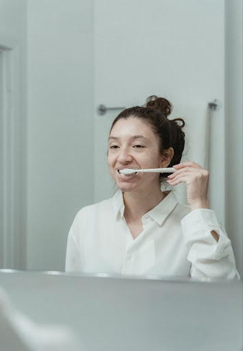A woman brushing her teeth
