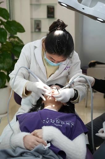 A dentist performs a dental procedure on a patient