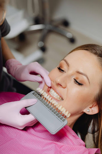 Dentist comparing tooth shades on patient