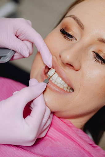 A dentist matching tooth sample to patient's teeth