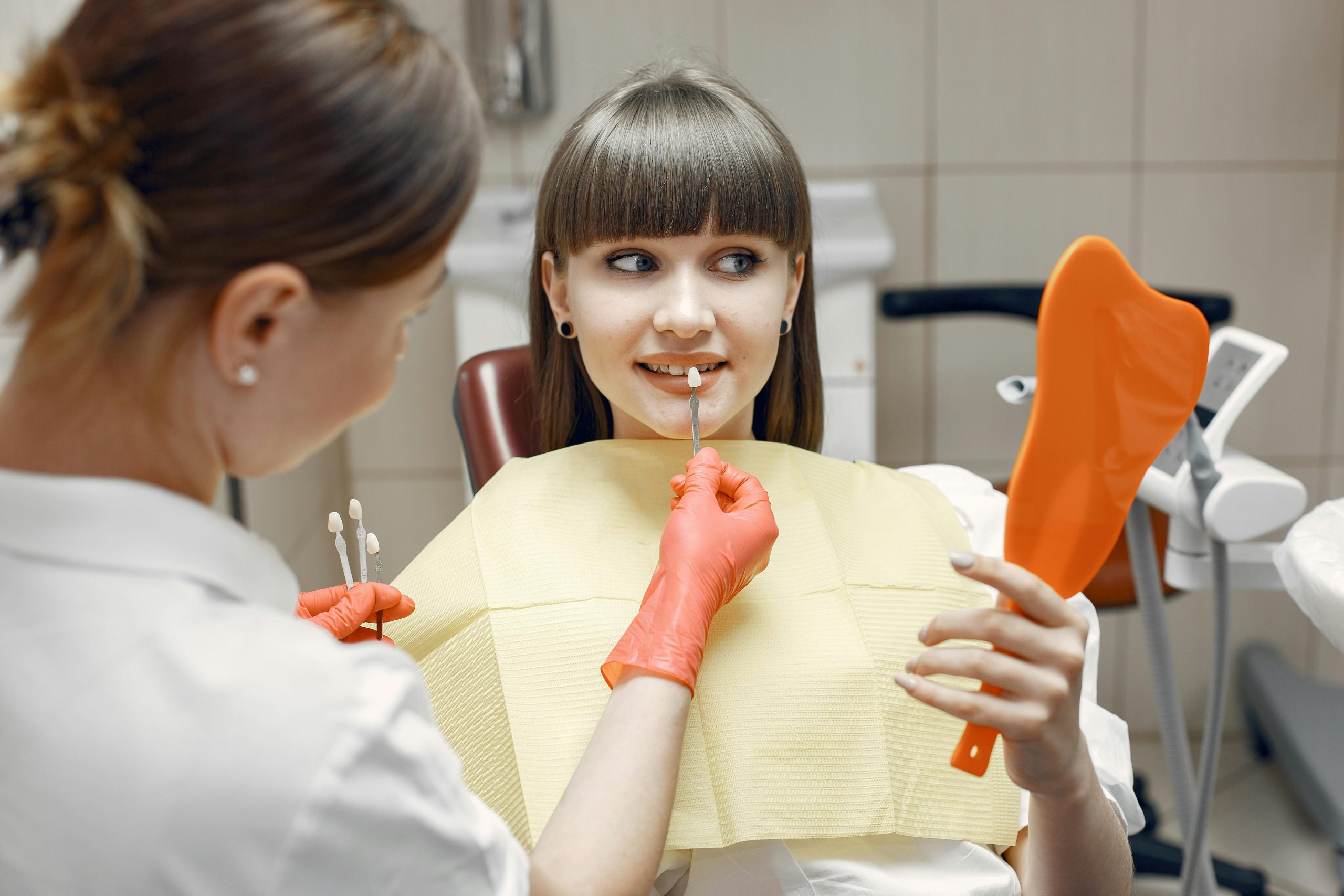 Dentist matching patient's tooth color